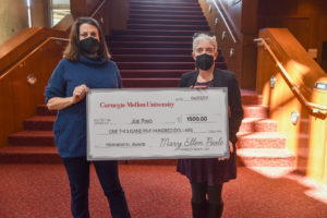 Anne Mundell and Mary Ellen Poole hold an oversized check to be awarded to Joe Pino as the recipient of the Hornbostel Award